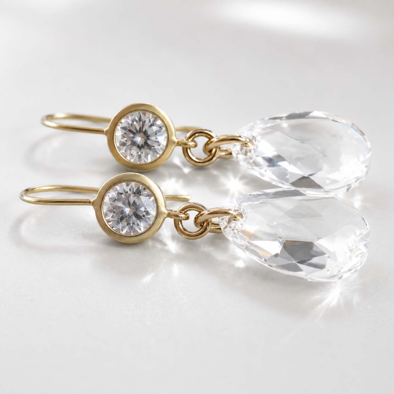 Clear crystal dangle earrings on matte gold