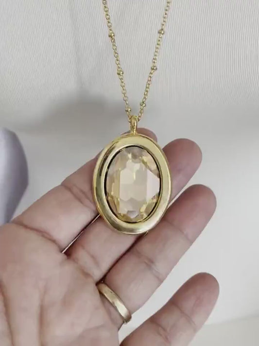 Large gold oval crystal pendant