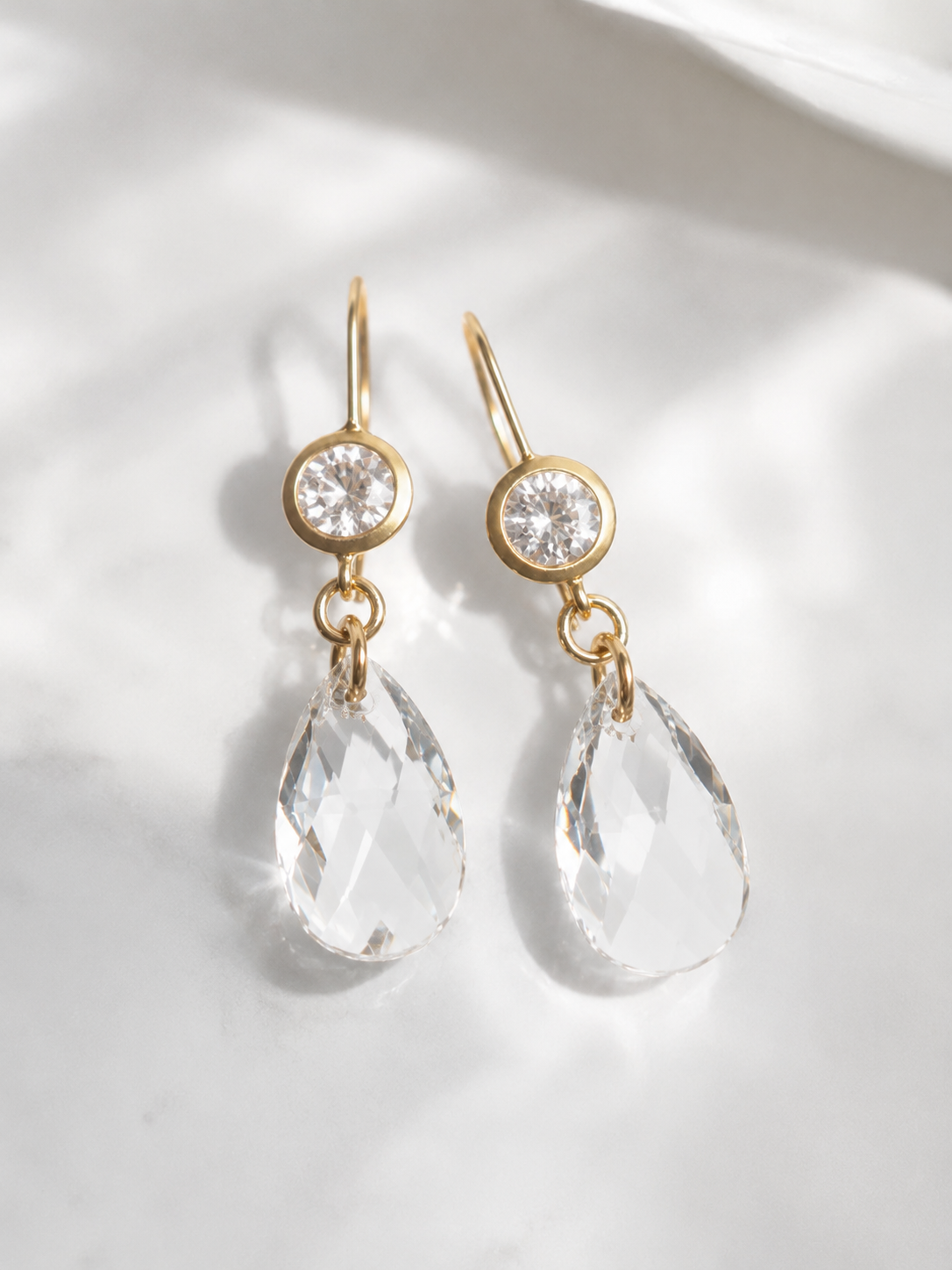Clear crystal dangle earrings on matte gold
