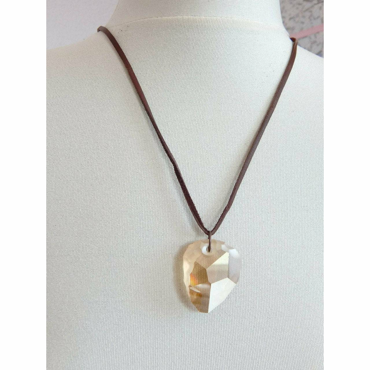 Golden rock crystal pendant on leather necklace